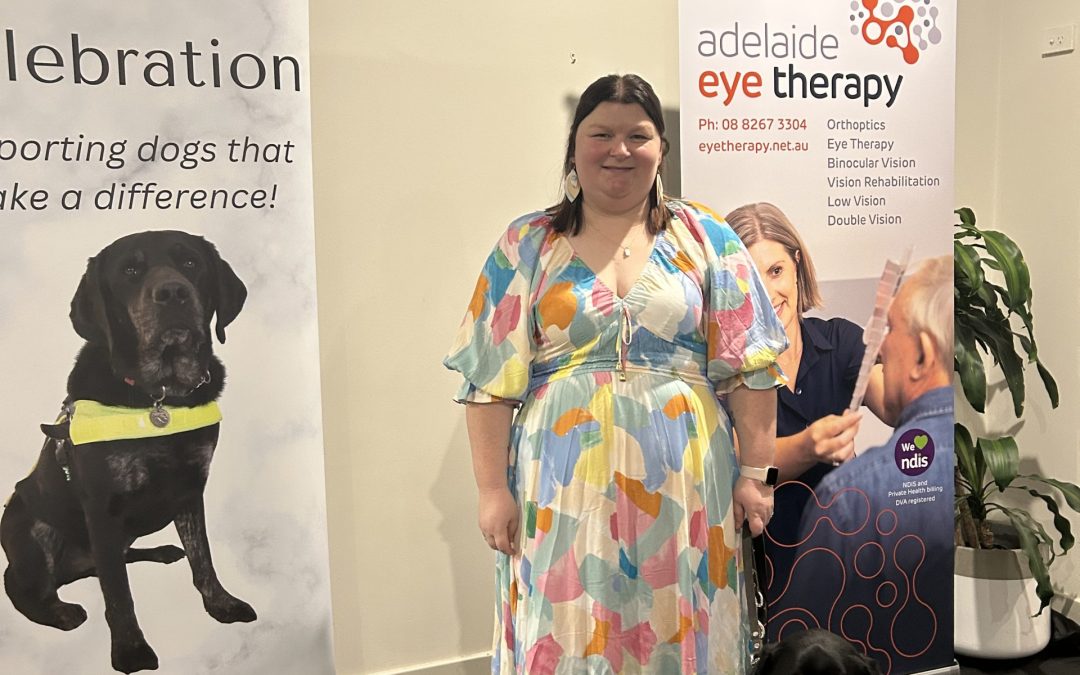 Charlotte standing with her dog at the dinner party
